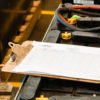Forklift Battery Inspection Paperwork on Clipboard