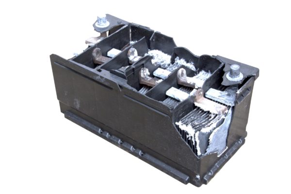 A damaged lead-acid battery with plates exposed