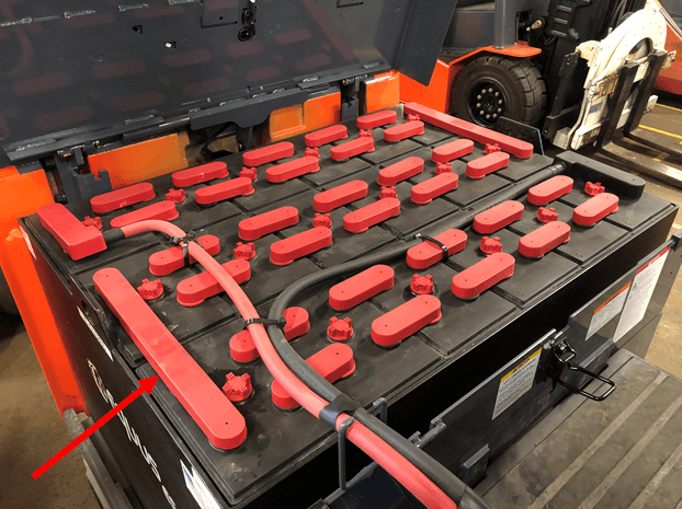A forklift battery, with an arrow pointing to an intercell connector