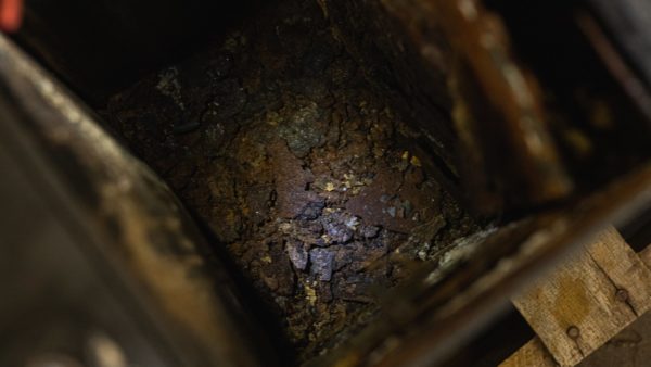 Sludge and rust inside a forklift battery case