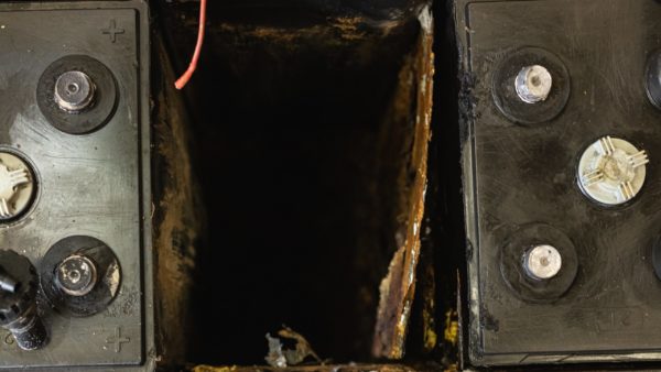 A severely corroded battery cell divider