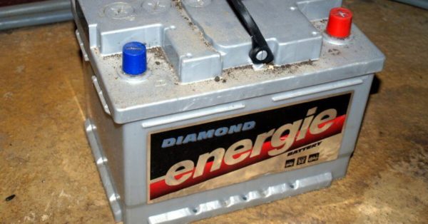A battery sitting on a concrete floor