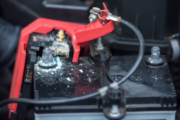 dirty-battery A car battery with a corroded positive terminal
