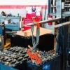 A forklift lifting a battery cell out of a forklift battery